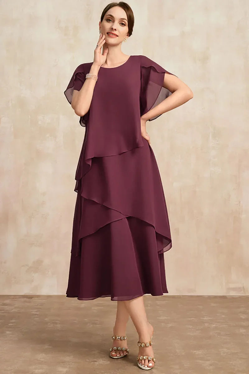 Unique women's flowy tiered midi dress. Asymmetrical layers and puff sleeves create an elegant, modern silhouette.