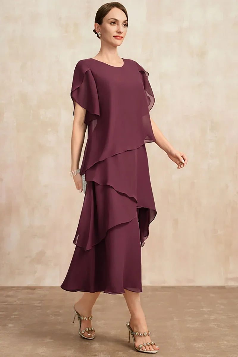 Model wears a women's asymmetrical tiered midi dress. Flowy layers and puff sleeves offer comfort and style.