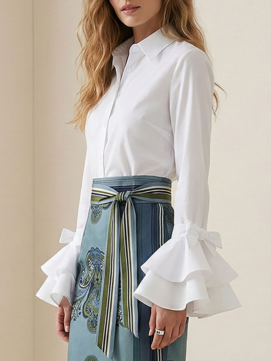Chic women's button up blouse with tiered body and elegant ruffle flare sleeves.