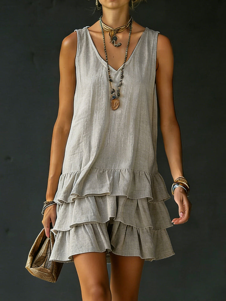 Elegant casual women's tiered ruffle mini dress. Sleeveless V-neck, relaxed for spring/summer vacation.