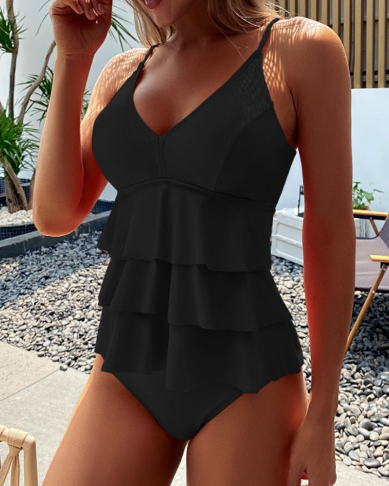 Flattering women's layered ruffle tankini top with V-neck, providing support for stylish beachwear & summer fun.