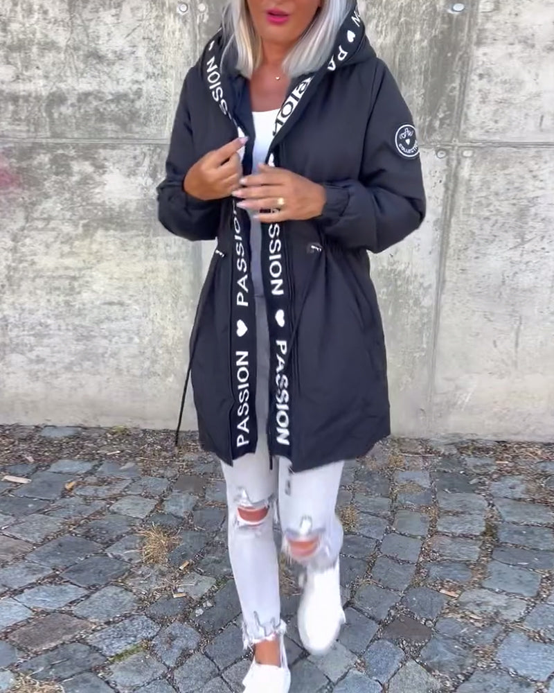 Functional women's hooded trench, a zip-front, lightweight outerwear piece. Ideal for unpredictable weather.