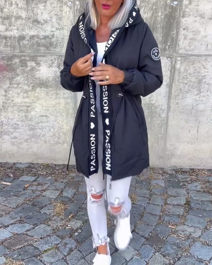 Functional women's hooded trench, a zip-front, lightweight outerwear piece. Ideal for unpredictable weather.