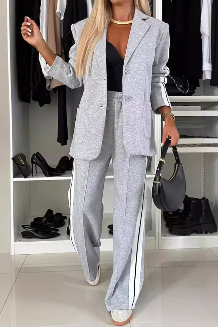 Women's track stripe blazer & wide leg pant set. Stylish two-piece co-ord for casual or sporty chic comfort.