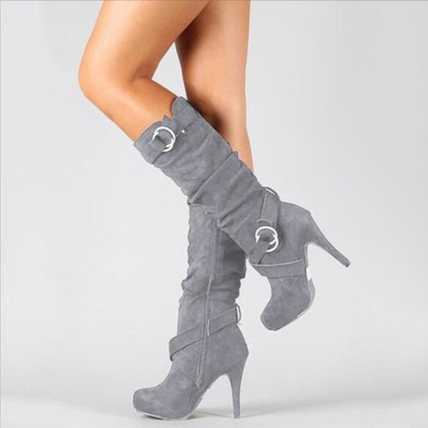 Women's trendy black high heel boots with chic buckle details, perfect for stylish autumn fashion.