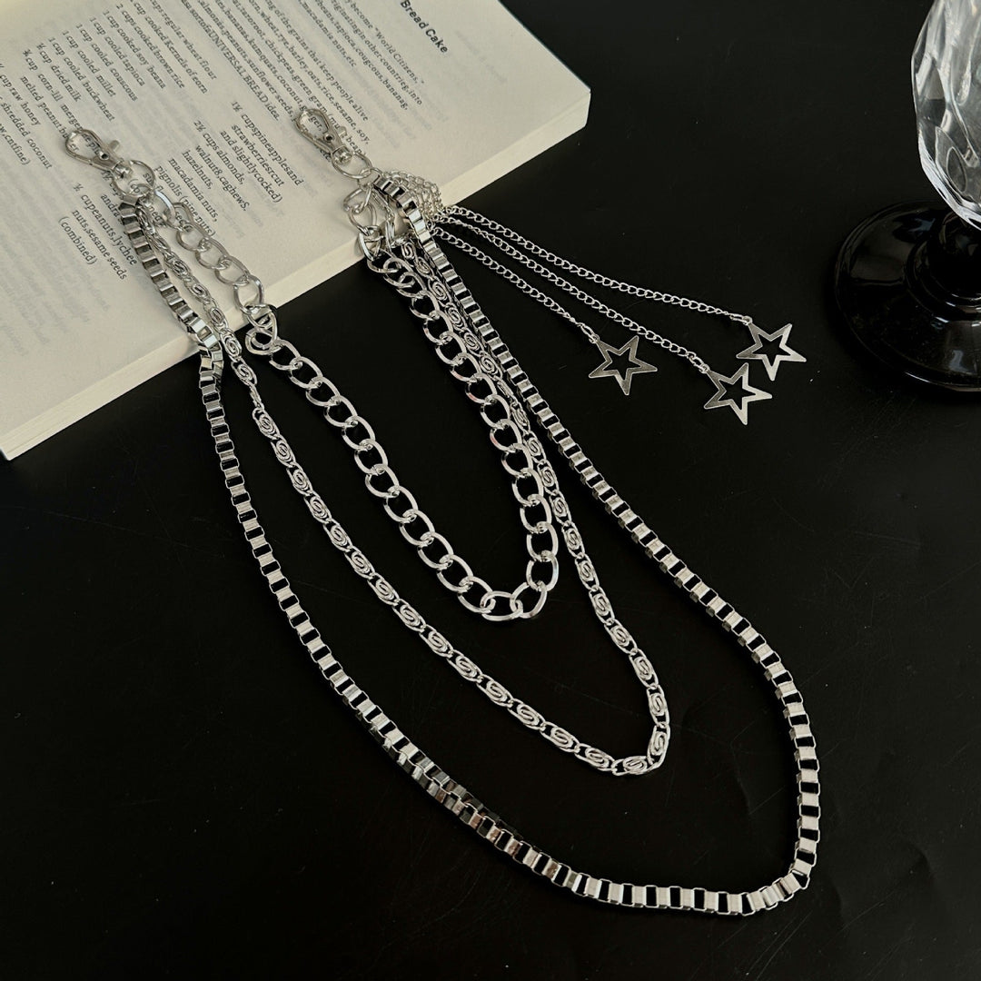 Fashionable women's star pendant chain belt. Trendy gold-tone metal accessory, adjustable for waist or hip styling.