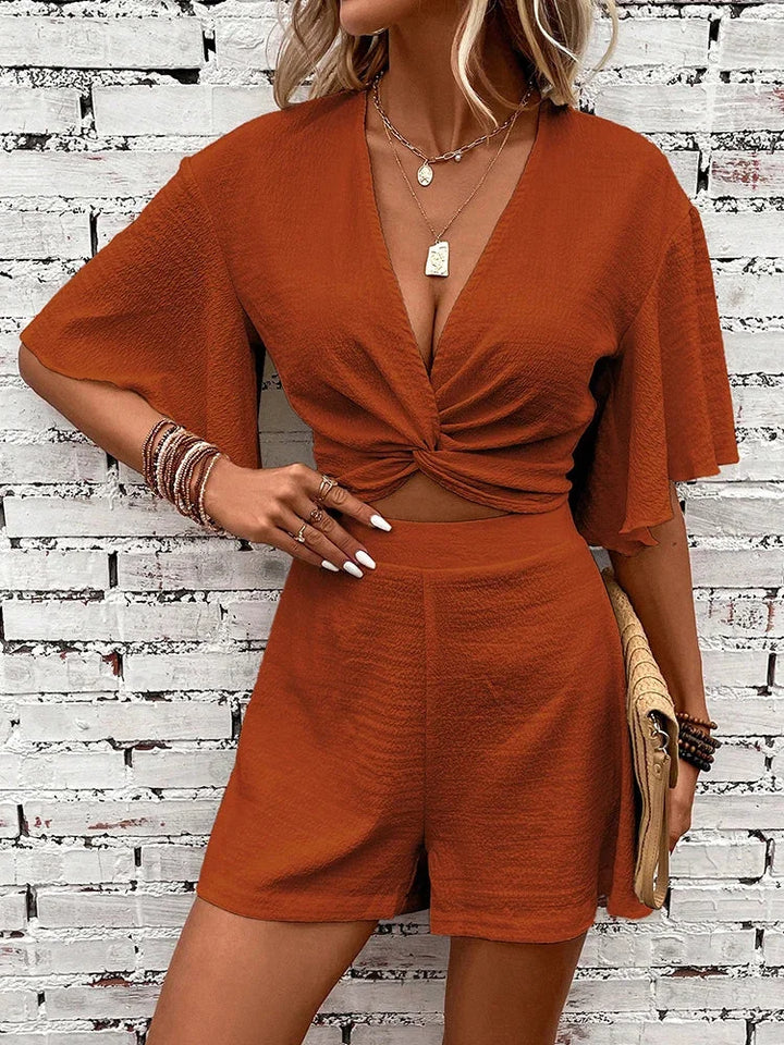 Fashionable women's textured V-neck crop top and high-waist shorts two-piece set, perfect for summer chic.