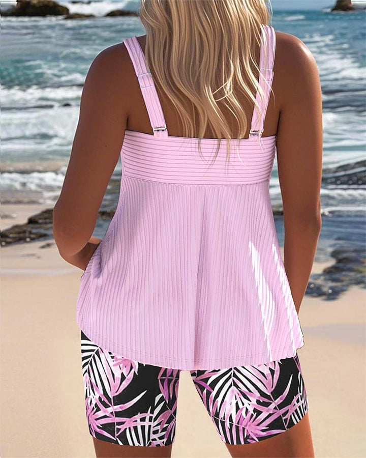 Comfortable women's two-piece tankini swimsuit with tropical shorts, great for summer poolside style.