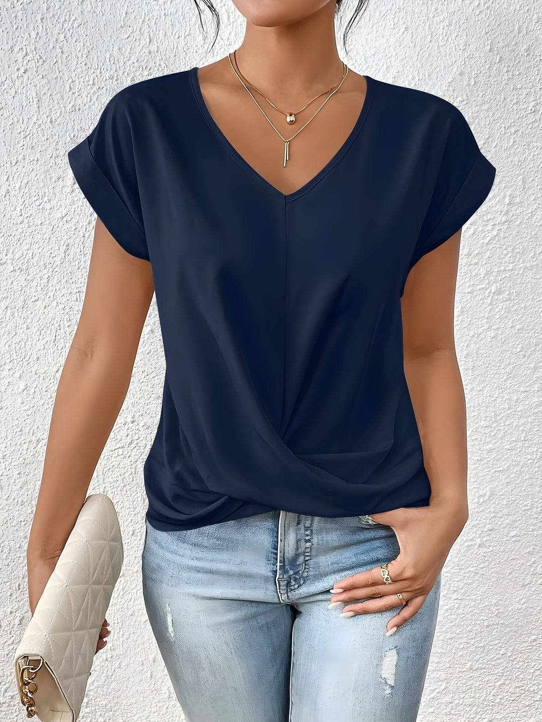 Comfortable women's short sleeve V-neck blouse with a trendy twist front, ideal for casual and stylish everyday outfits.
