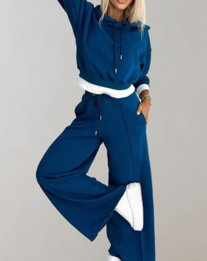 Matching women's loungewear set: cozy hoodie & wide leg trousers. Ideal for comfortable casual wear & relaxing at home.