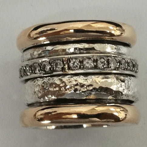 Women's two-tone layered ring with hammered gold and sparkling crystal-set silver bands; a chic fashion accessory.