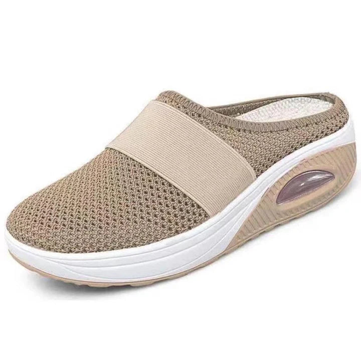 Woman wearing lightweight air-cushion slip-on walking shoes, demonstrating comfort and casual style.