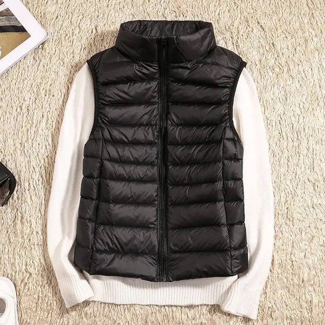 Women's ultra-light down vest. Warm, lightweight puffer vest, perfect for layering & travel essentials.