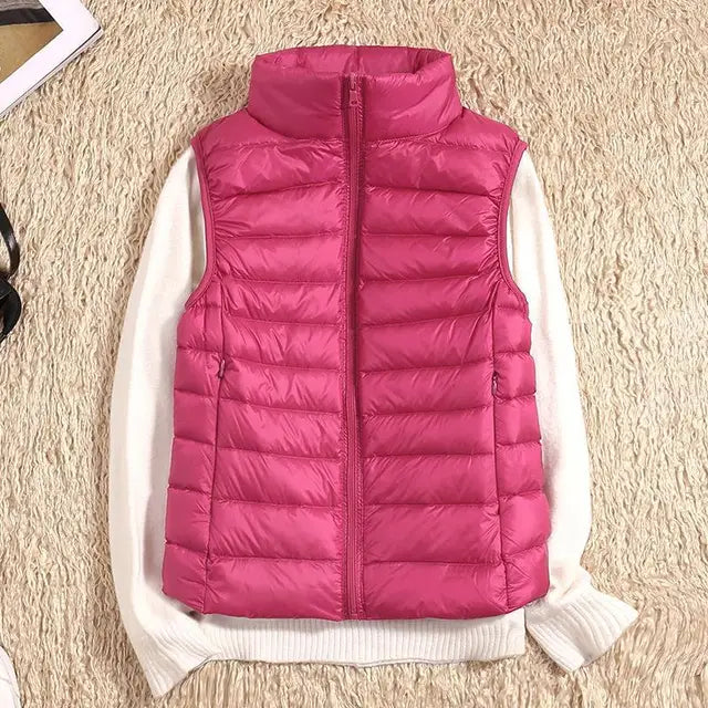 Women's essential down vest. Ultra-light, warm, and versatile for layering or travel.