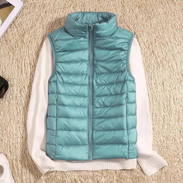 Elegant women's ultra-light down vest. Sleeveless jacket, warm & packable for travel essentials.