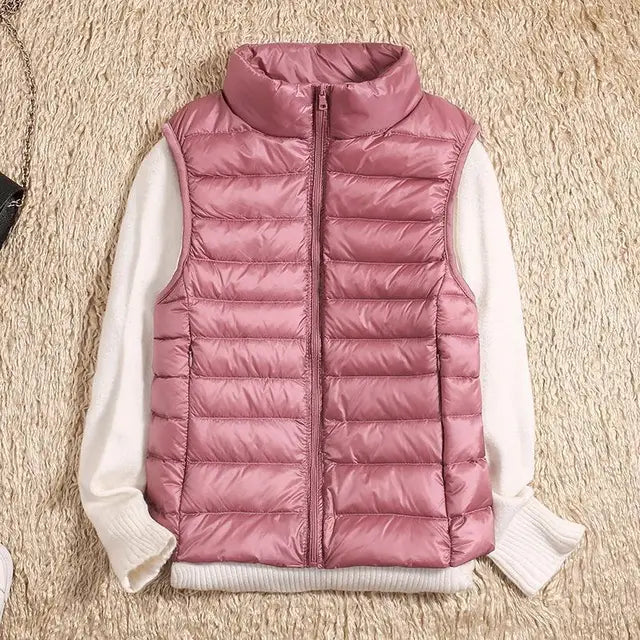 Warm women's down vest. Lightweight sleeveless jacket, perfect for travel & outdoor layering.