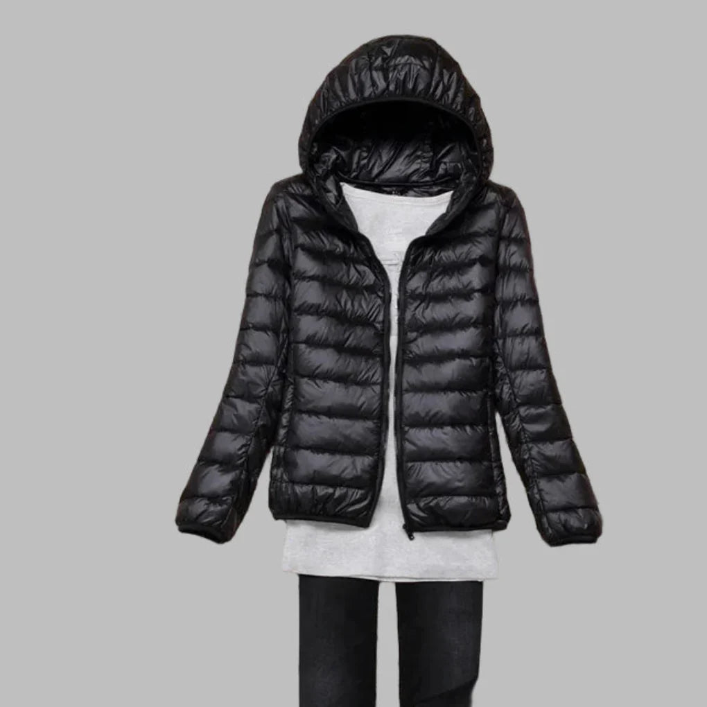 Women's ultra-light packable winter puffer coat with hood, ideal for travel & outdoor adventures.