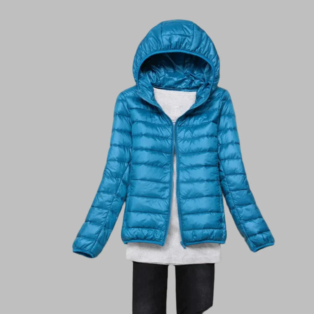 Stylish women's hooded puffer jacket, lightweight & versatile for cold weather winter fashion.