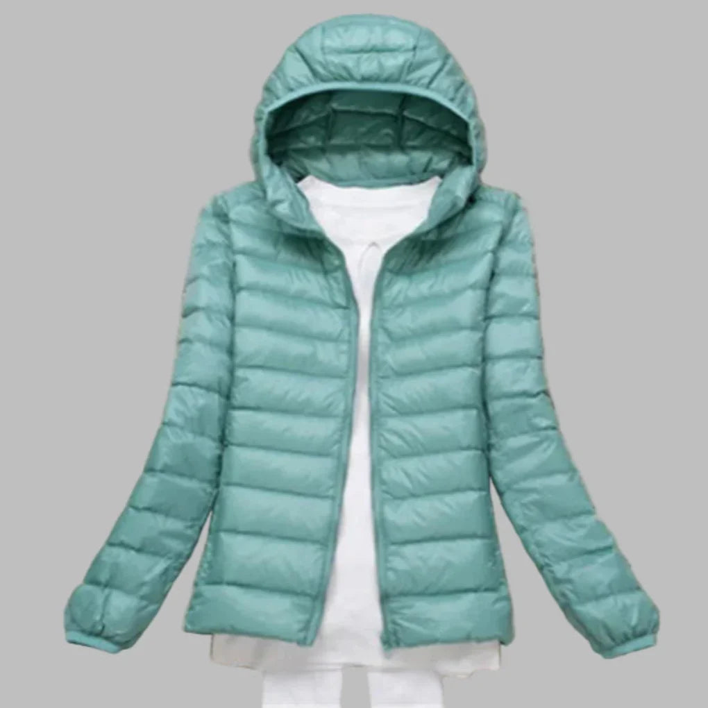 Female's warm packable hooded winter coat, essential outerwear for travel & outdoor activities.