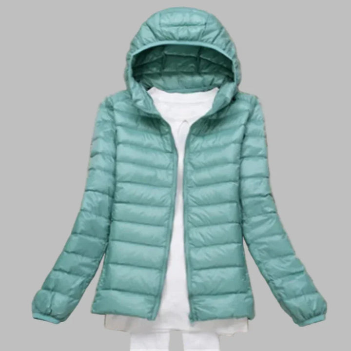 Female's warm packable hooded winter coat, essential outerwear for travel & outdoor activities.