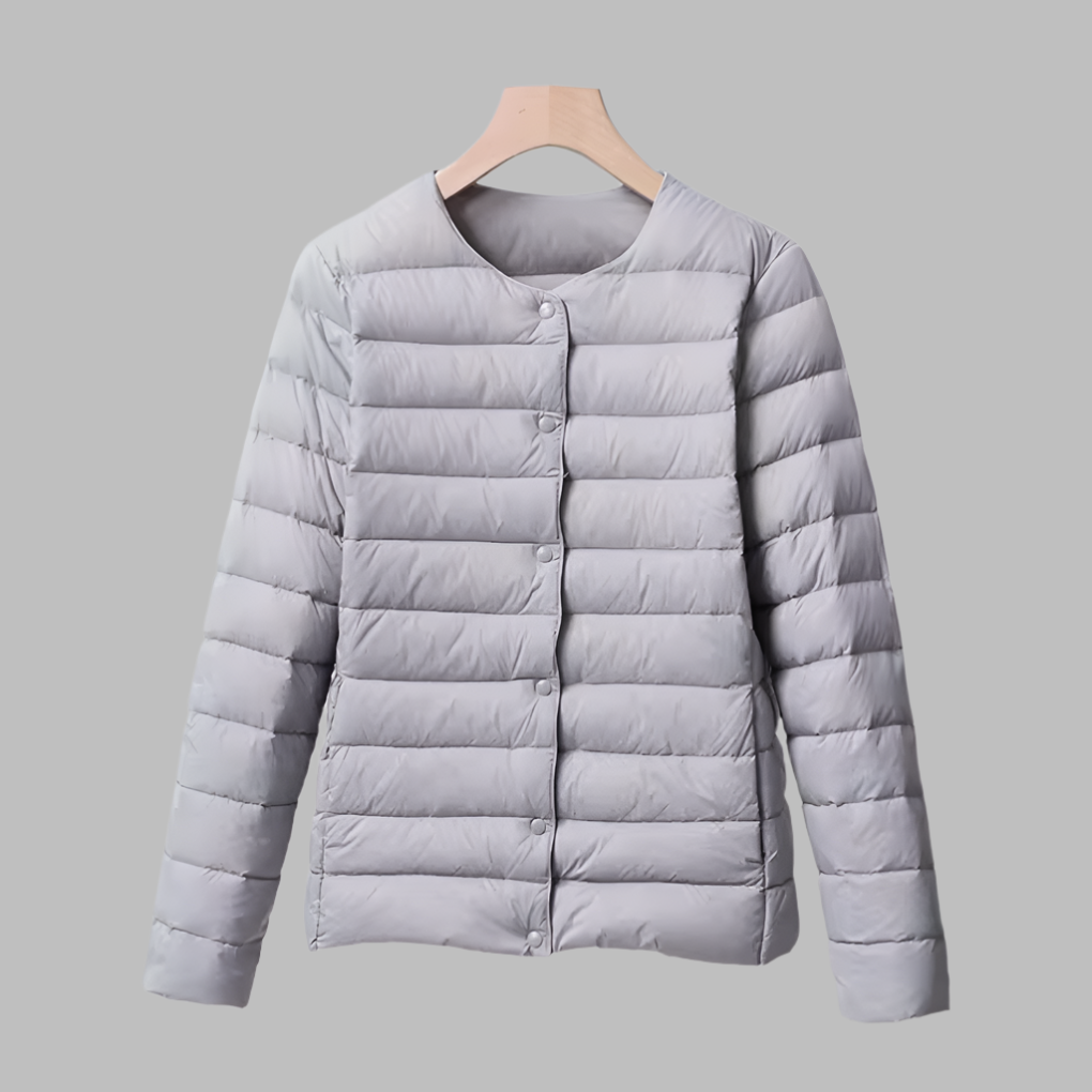 Travel-friendly women's ultralight collarless puffer jacket. Packable down outerwear for versatile layering.