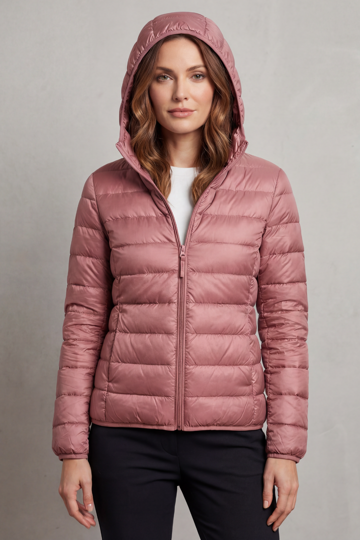 Women's travel puffer jacket with hood, ultralight and packable for adventure.