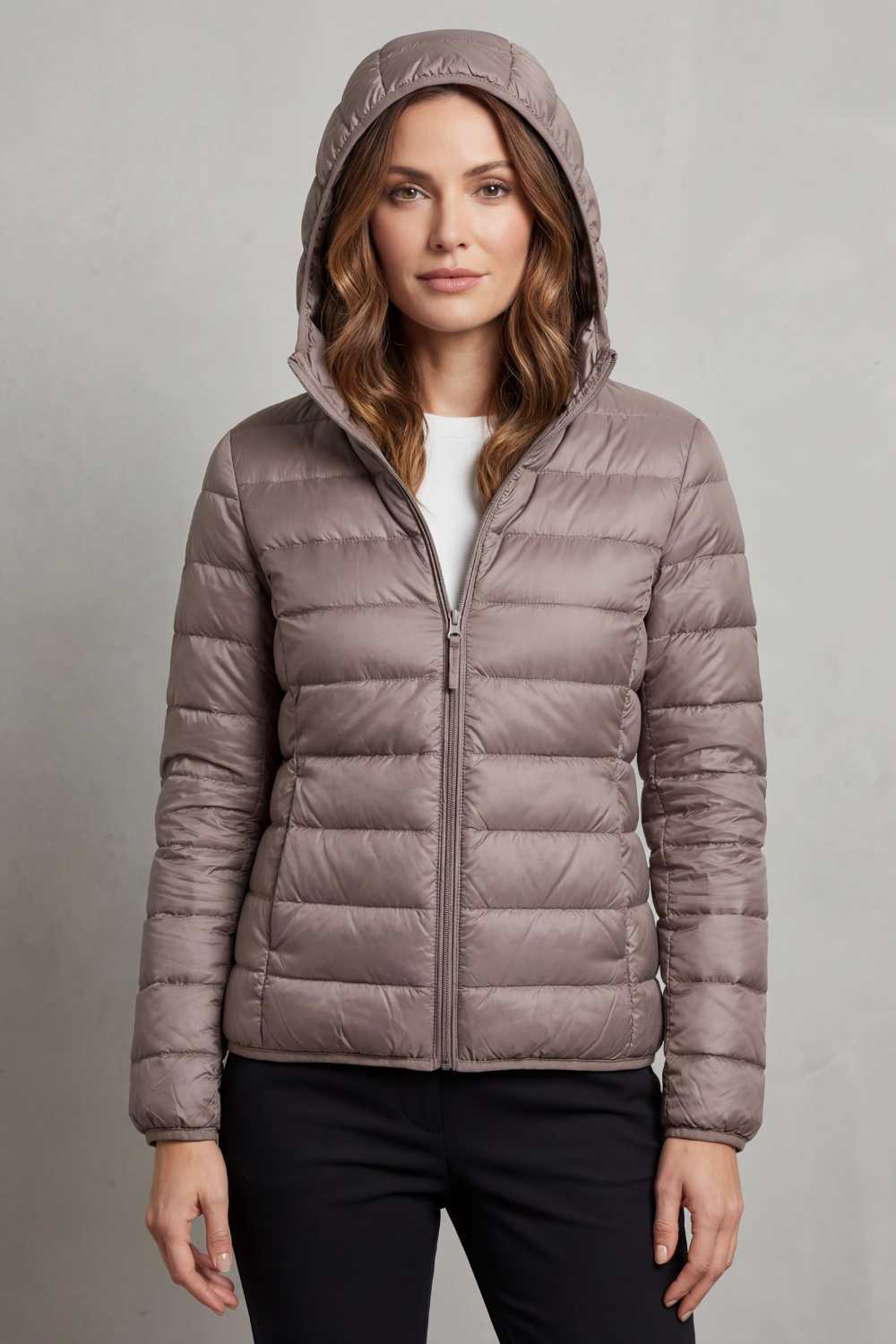 Stylish women's ultralight puffer jacket with hood, ideal for fall & winter travel.