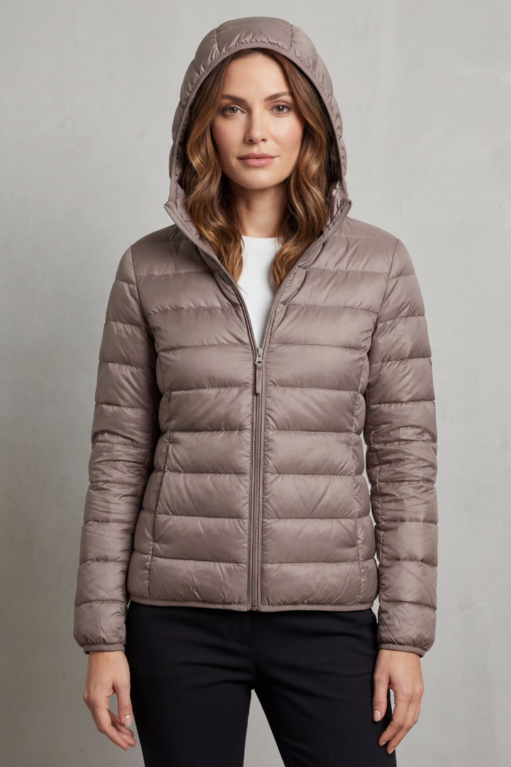 Stylish women's ultralight puffer jacket with hood, ideal for fall & winter travel.