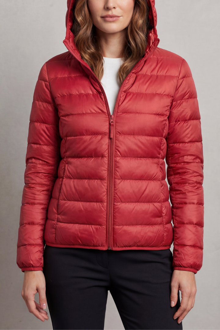 Stylish women's hooded puffer, ultralight travel jacket for warmth and comfort.