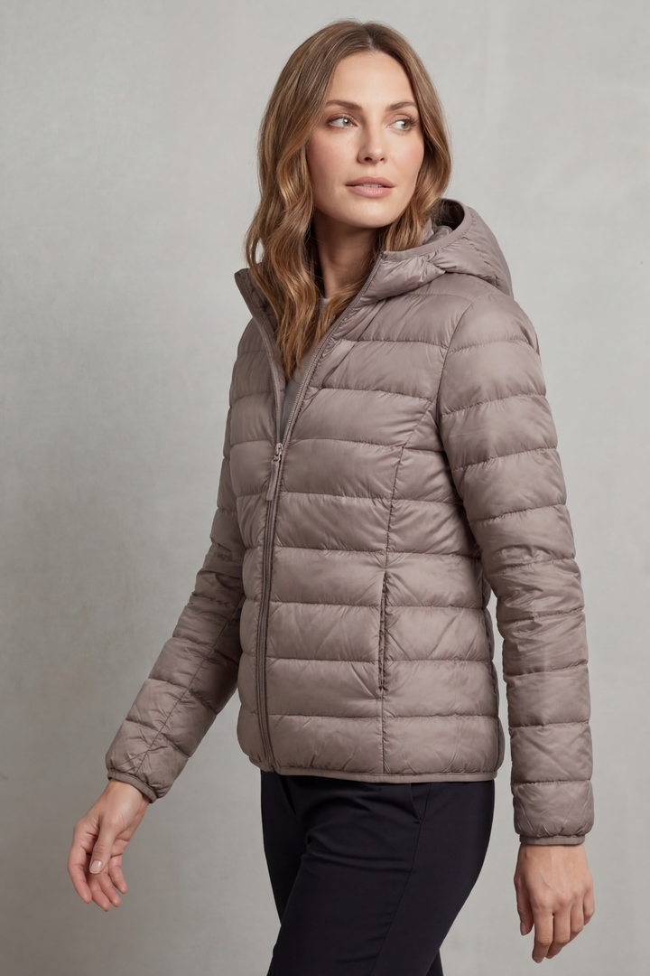 Warm, packable women's hooded puffer coat, perfect for cold weather & travel.