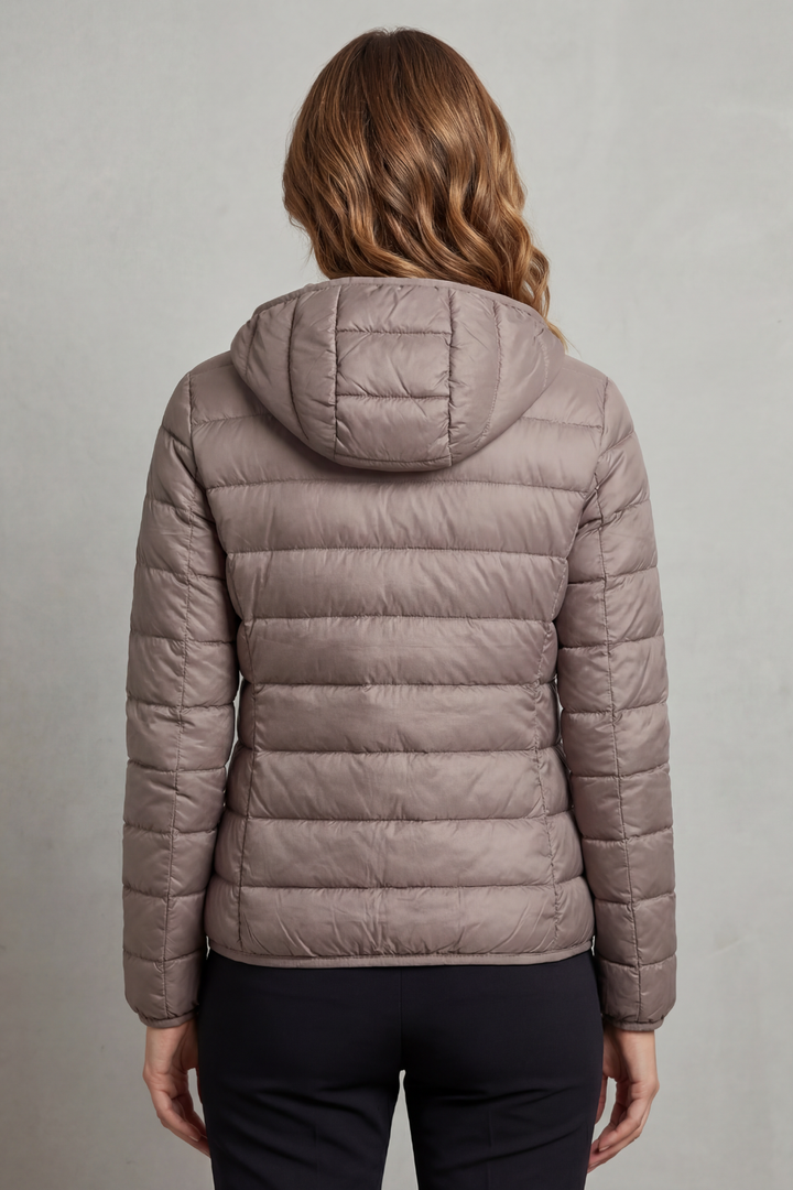 Ultralight women's puffer jacket, hooded & packable, great for fall, winter, & travel.