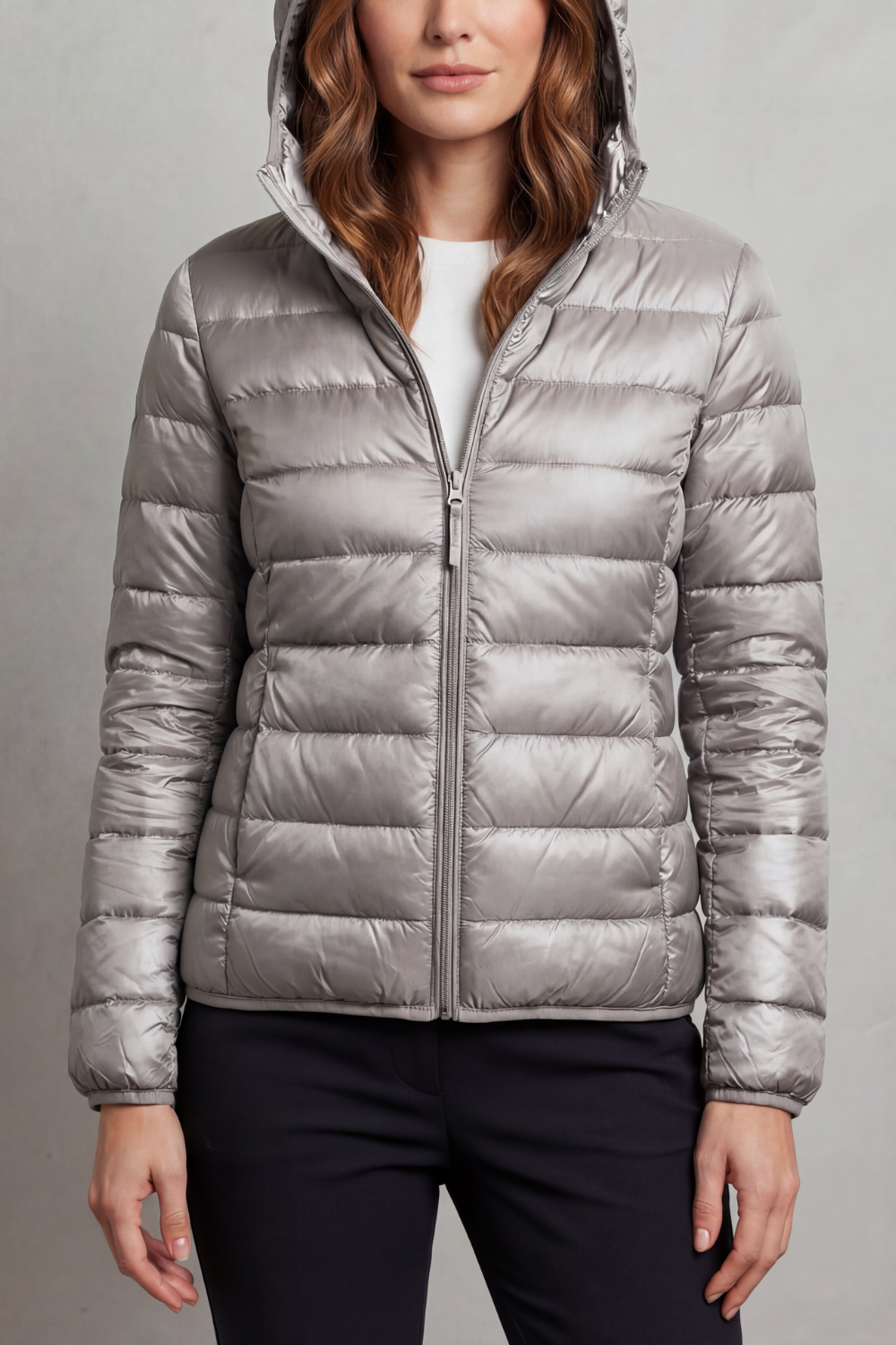 Fashionable women's hooded puffer jacket, ultralight & packable for versatile outerwear.