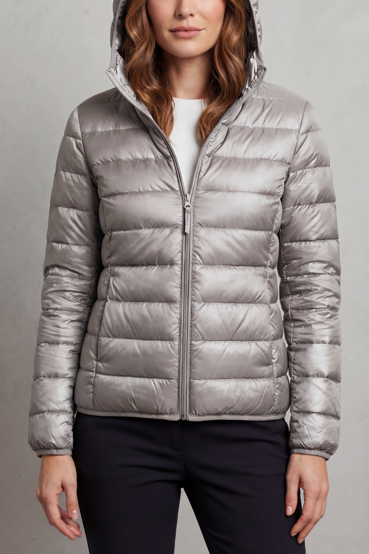 Fashionable women's hooded puffer jacket, ultralight & packable for versatile outerwear.