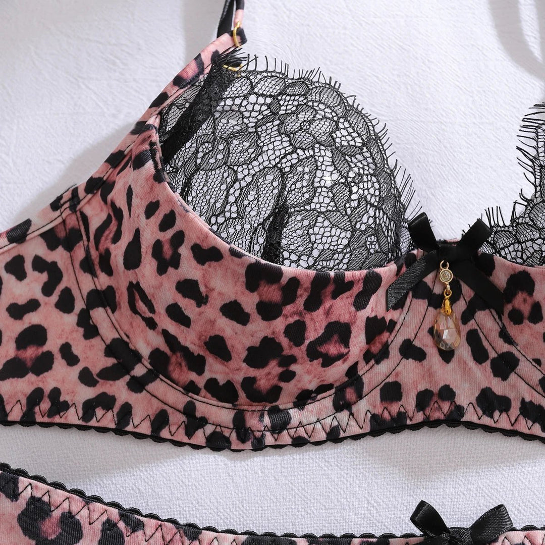 Four-piece women's intimate lingerie set: underwired leopard print bra, black lace garter, thong, and stockings.