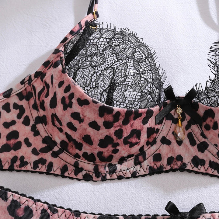 Four-piece women's intimate lingerie set: underwired leopard print bra, black lace garter, thong, and stockings.