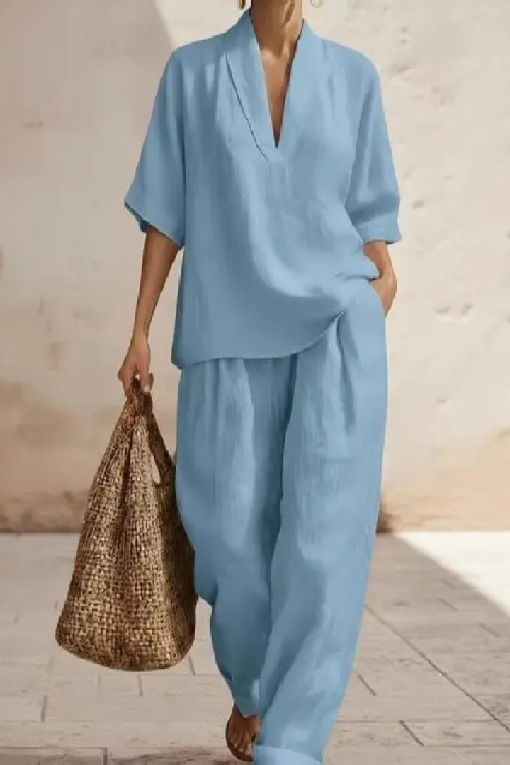 Fashionable women's V-neck co-ord, including a chic top and relaxed wide leg trousers.
