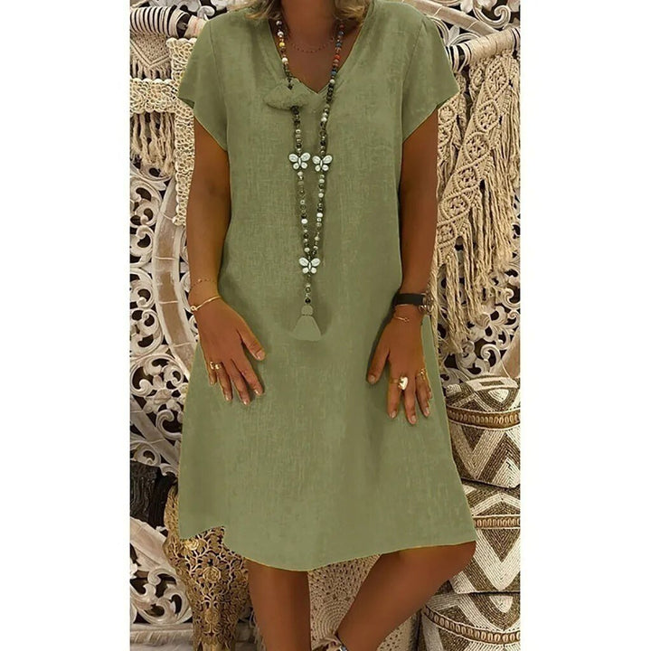 Lightweight short sleeve summer mini dress with a V-neck and A-line silhouette. Women's casual outfit.