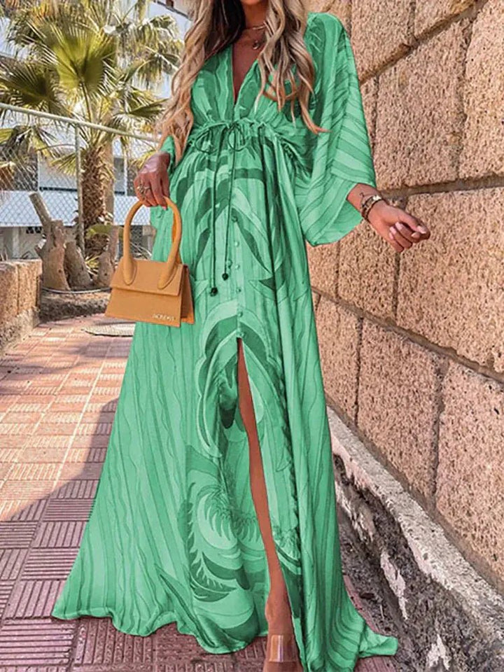 Stylish women's bohemian V-neck maxi dress with vibrant abstract print and elegant kimono sleeves, tie-waist.