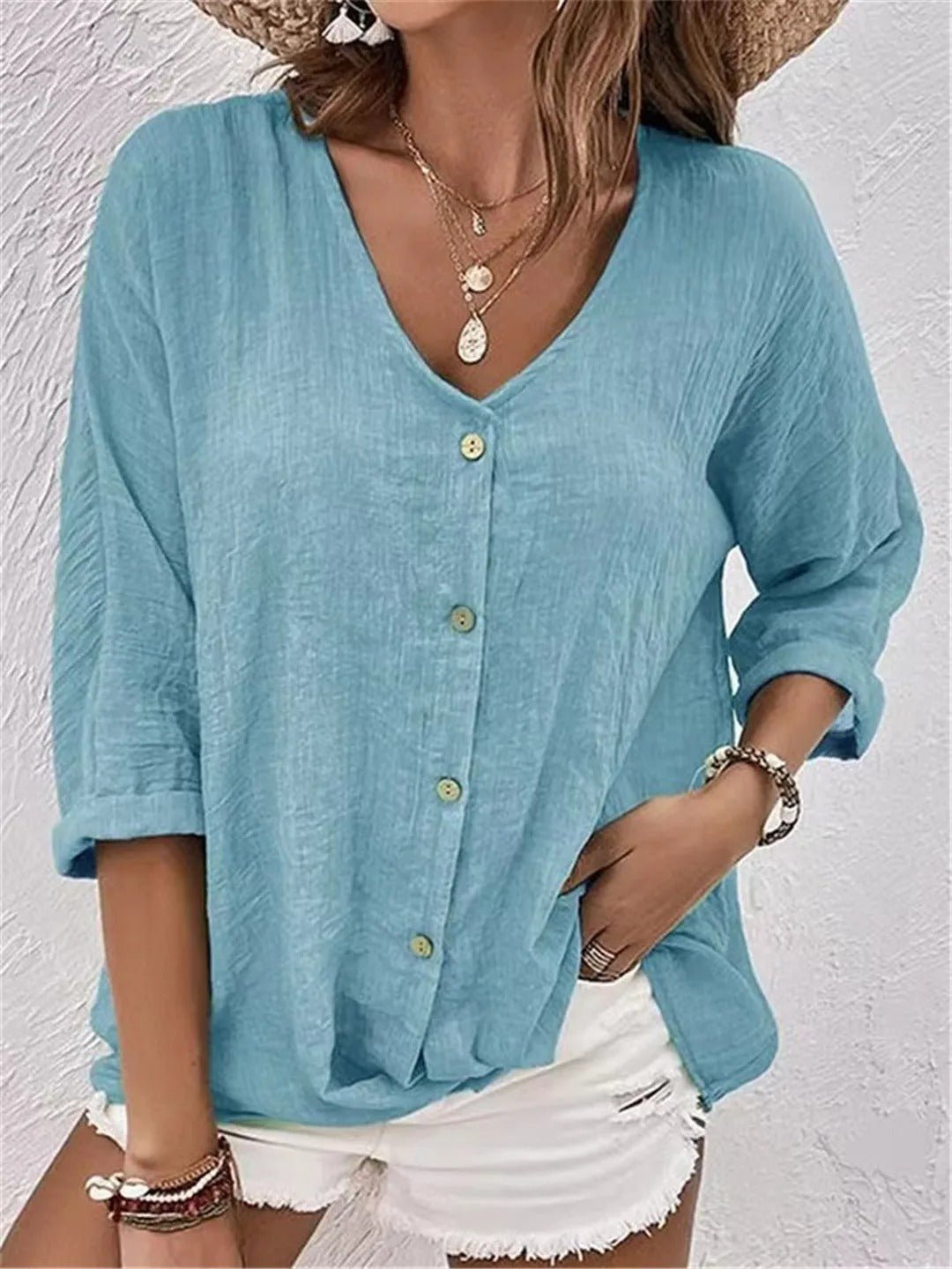 Women's V-neck button-front top with crinkle texture and 3/4 sleeves, perfect for casual summer style.