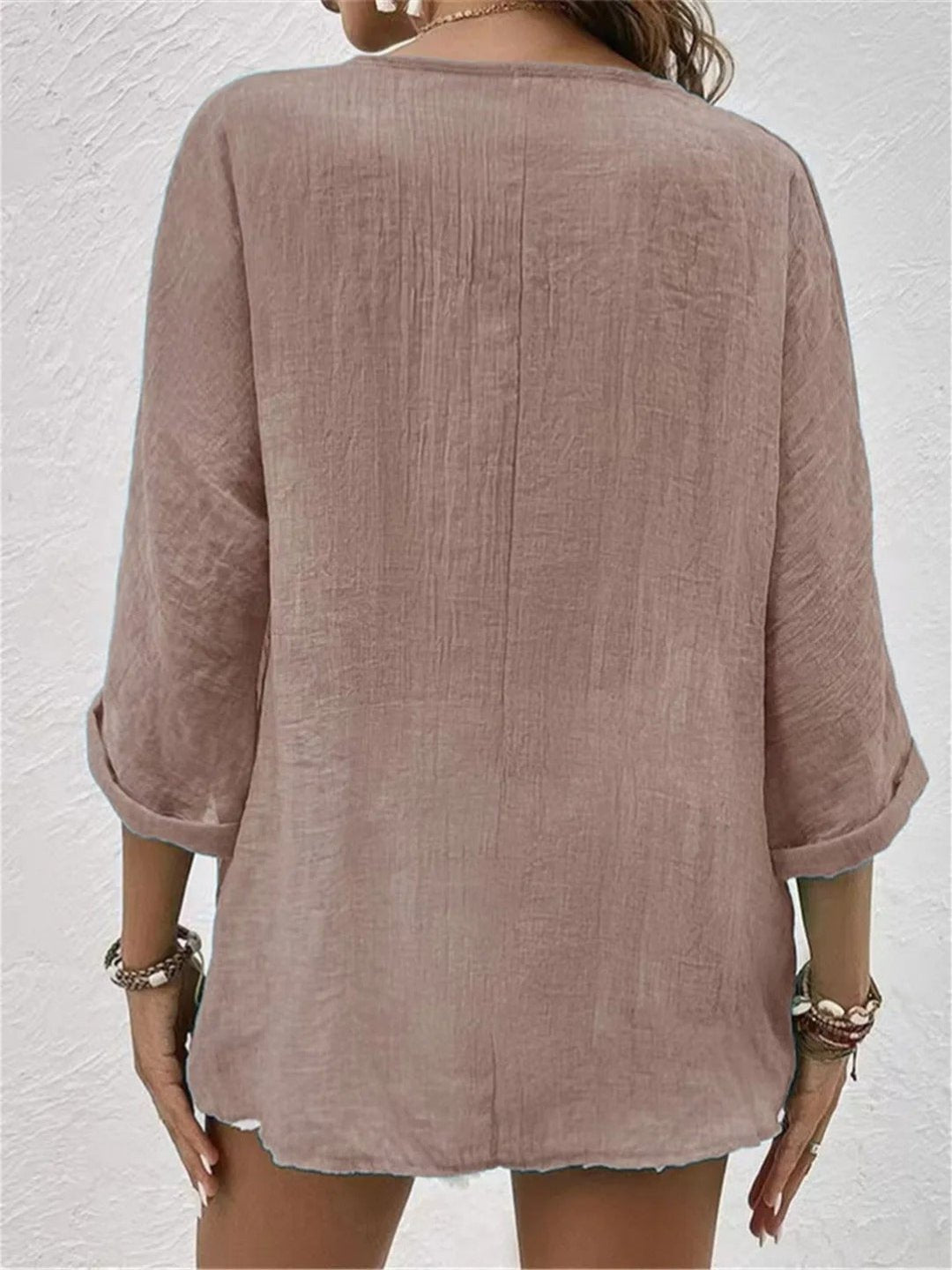 Oversized women's V-neck blouse with 3/4 sleeves & crinkle texture. A lightweight, versatile summer top.