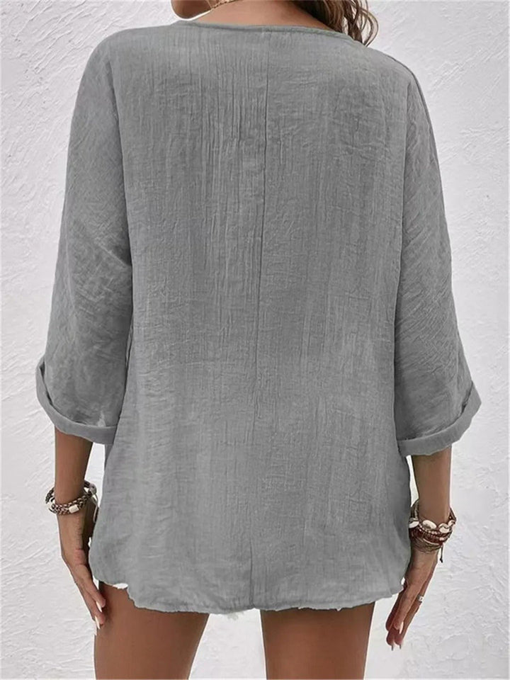 Comfortable women's crinkle texture V-neck blouse with 3/4 sleeves. A lightweight, relaxed fit for daily wear.