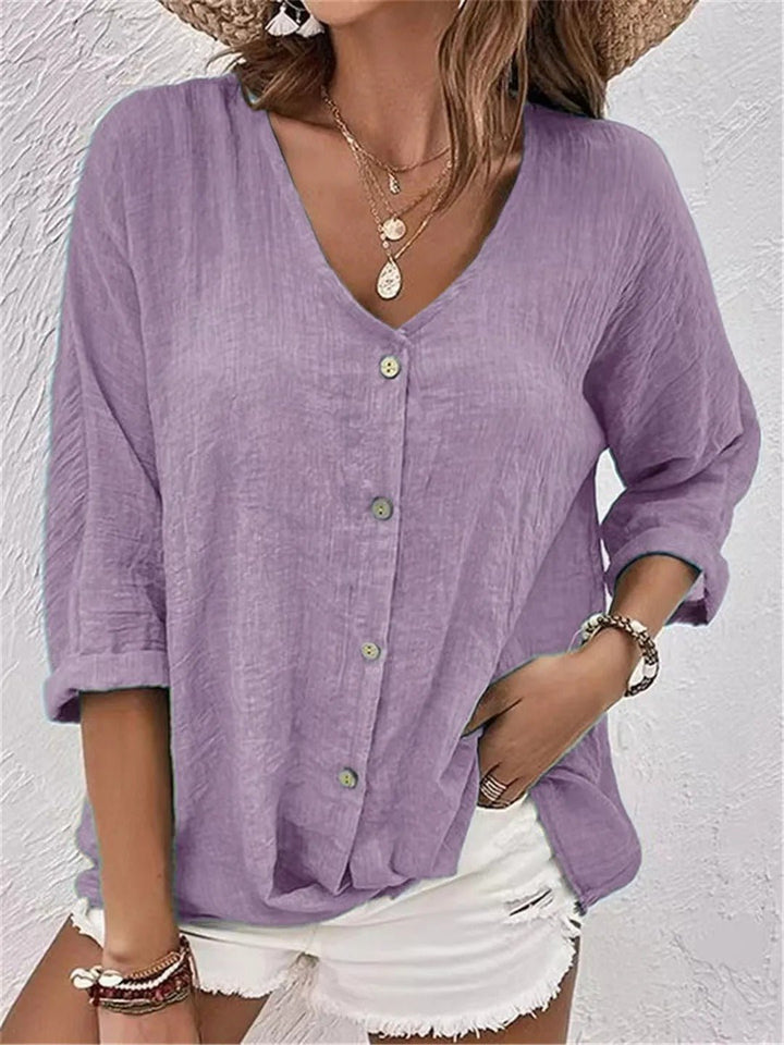 Summer-ready women's 3/4 sleeve V-neck button-front top, crinkle texture. Perfect for a breezy, casual look.