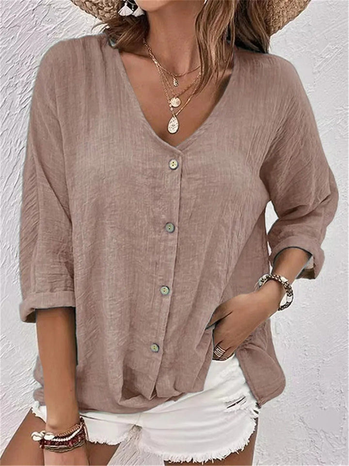 Women's elegant button-front top, V-neck, 3/4 sleeve. Features a unique crinkle texture for casual wear.