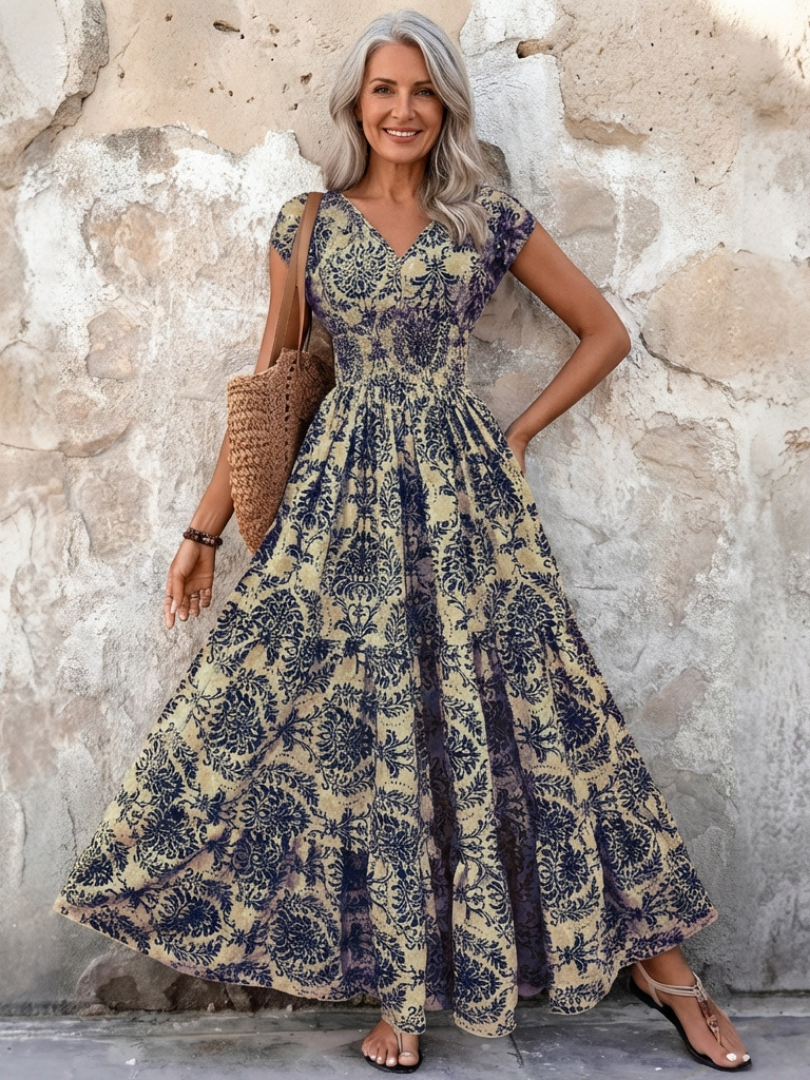 Women's V-neck cap sleeve bohemian maxi dress with flowing tiered skirt, perfect for summer elegance.