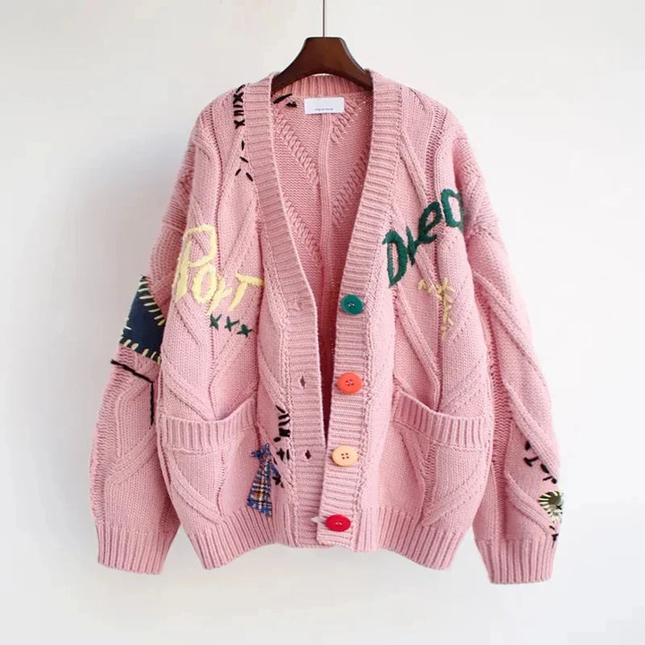 Stylish women's V-neck cardigan featuring intricate patchwork embroidery. Comfortable long sleeve knit for casual wear.