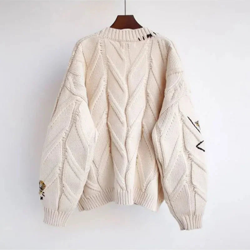 New women's V-neck cardigan with artisanal patchwork embroidery. Long-sleeve, cozy, and stylish for all seasons.