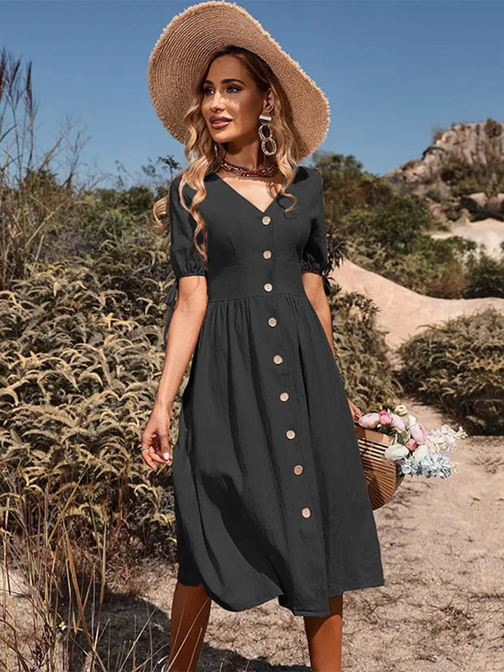 Green V-neck women's summer dress, knee-length, relaxed fit, short sleeve. Effortless casual elegance for spring.