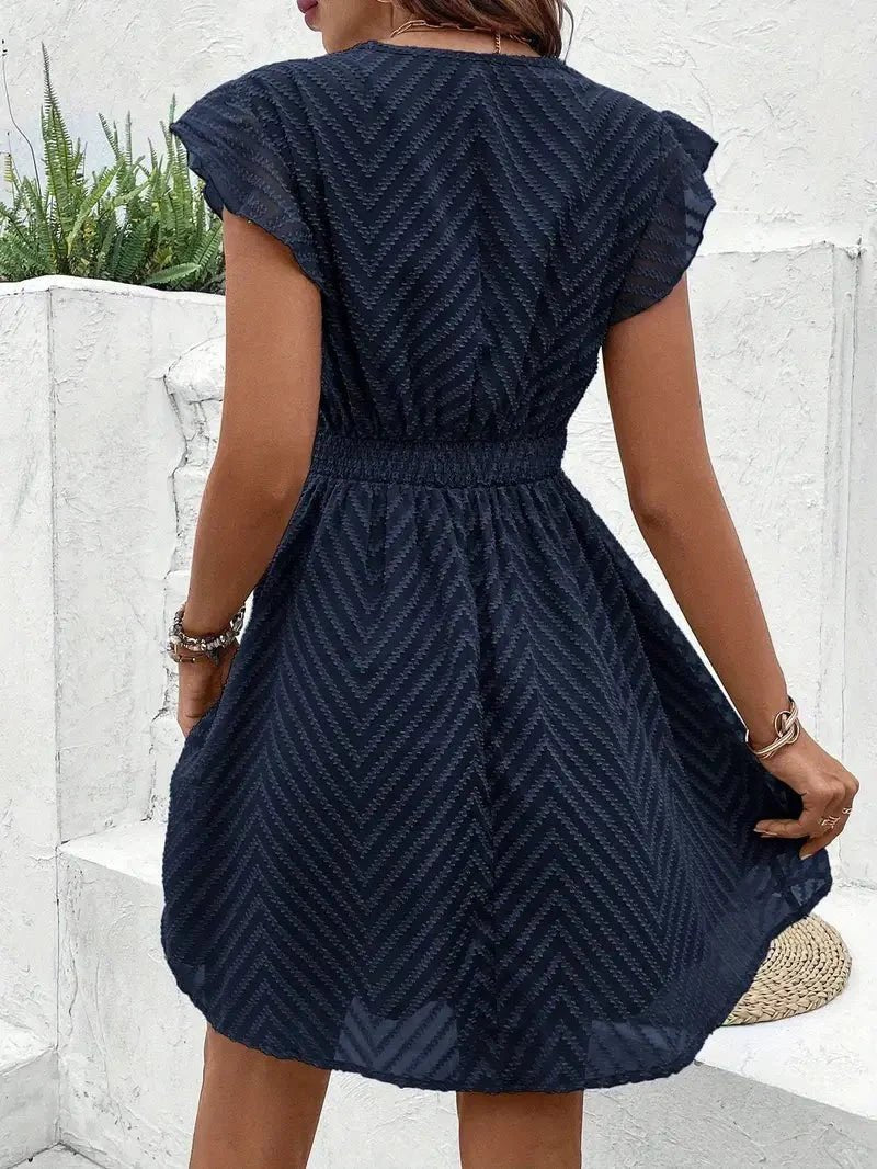 Women's cap-sleeve mini dress featuring V-neckline, lace trim, and a flattering flared silhouette.