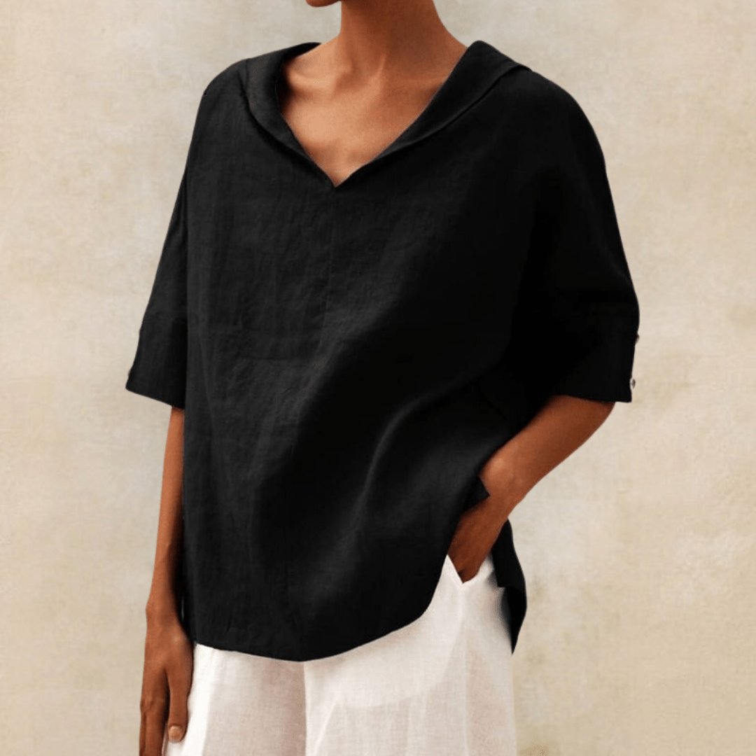 Model wearing a relaxed fit V-neck collared linen tunic blouse. Loose, comfortable women's top for casual summer style.