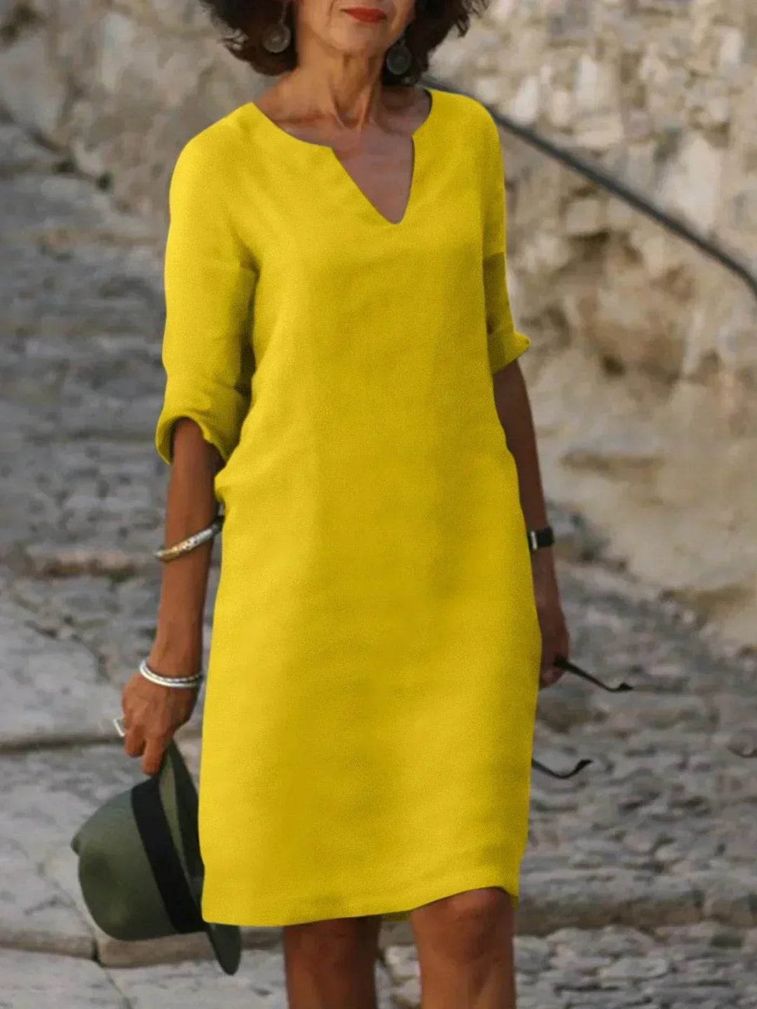 Everyday women's V-neck midi dress with 3/4 sleeves, relaxed fit, & functional pockets. Stylish & practical.